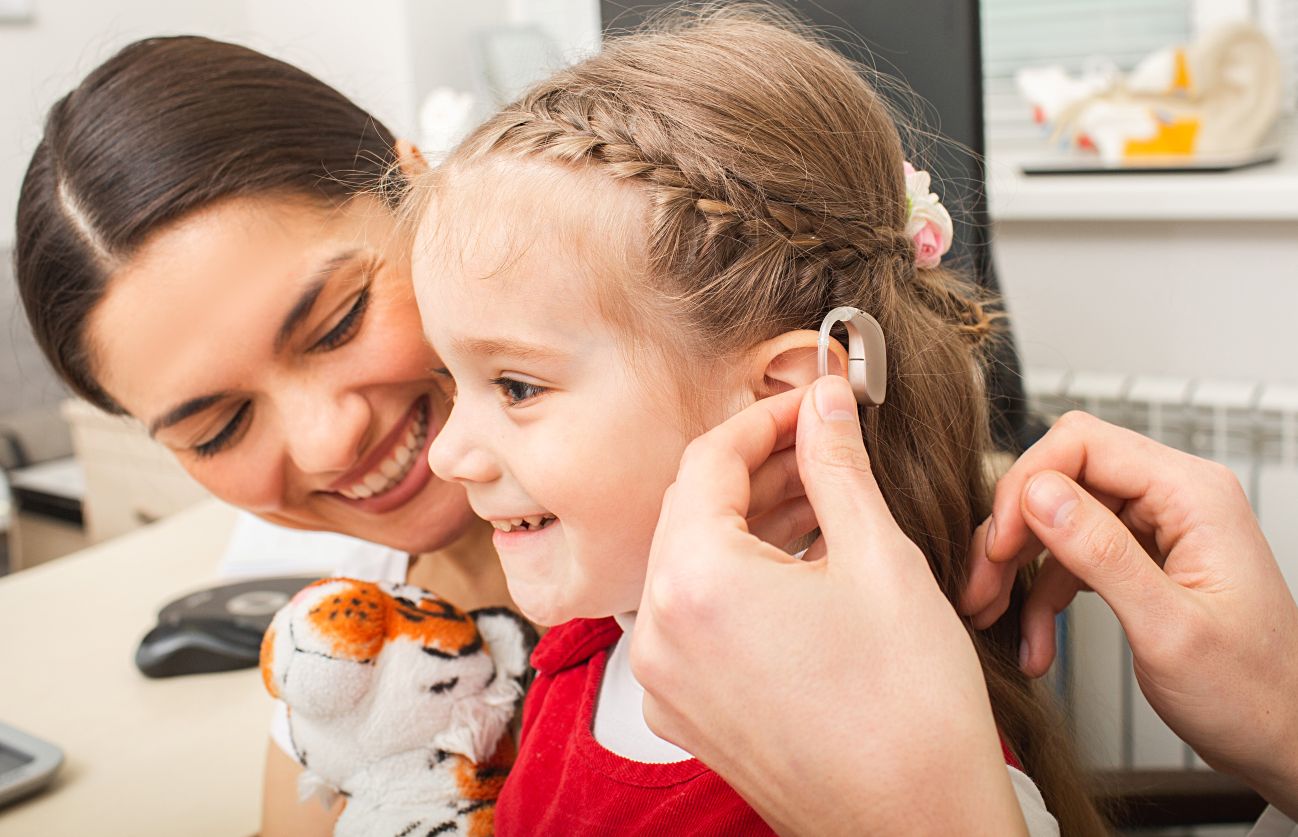 child receiving hearing aids
