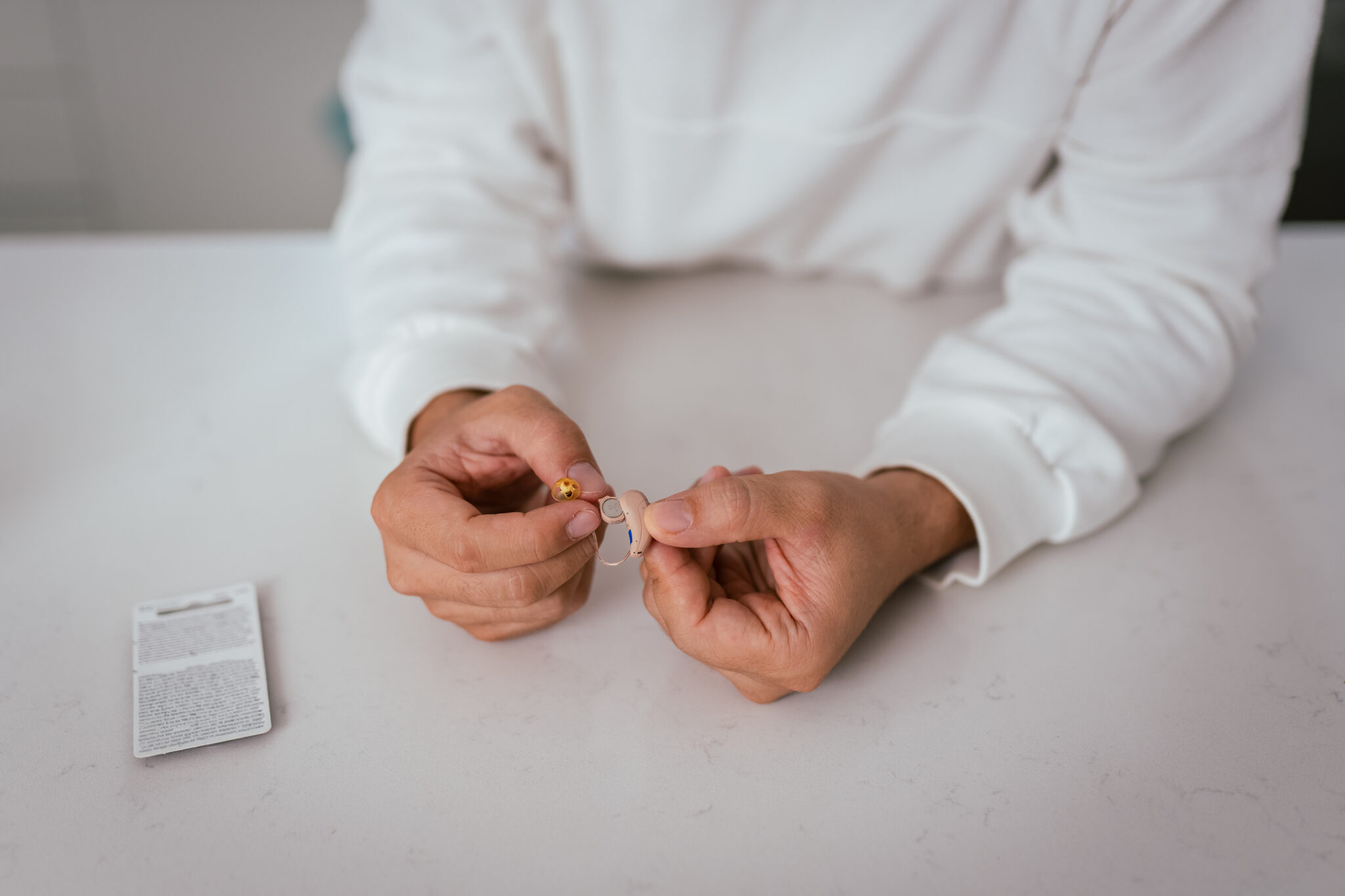 technician repairing hearing aids.